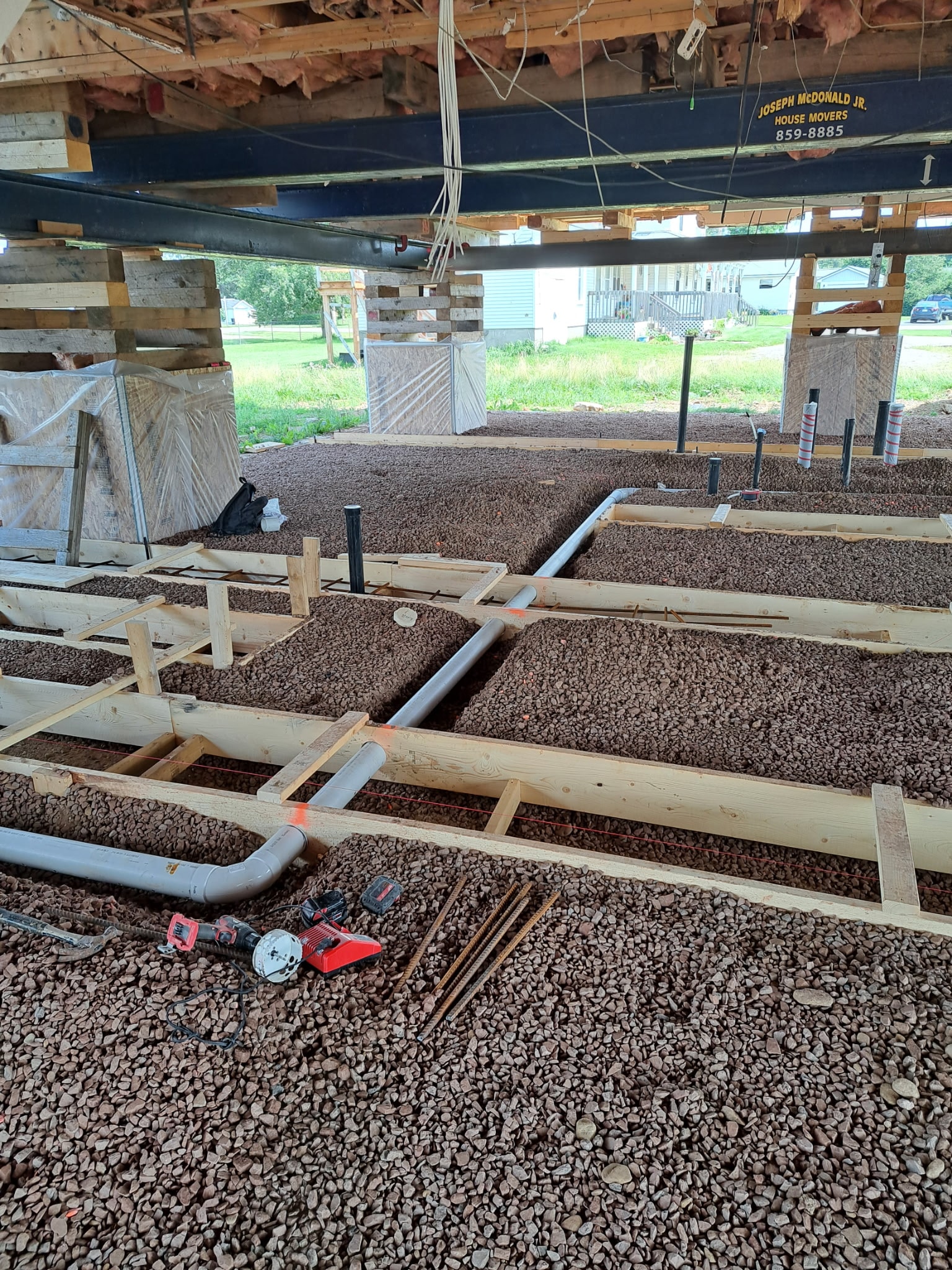 Radon rough-in system installation showing piping and gravel bed under new construction